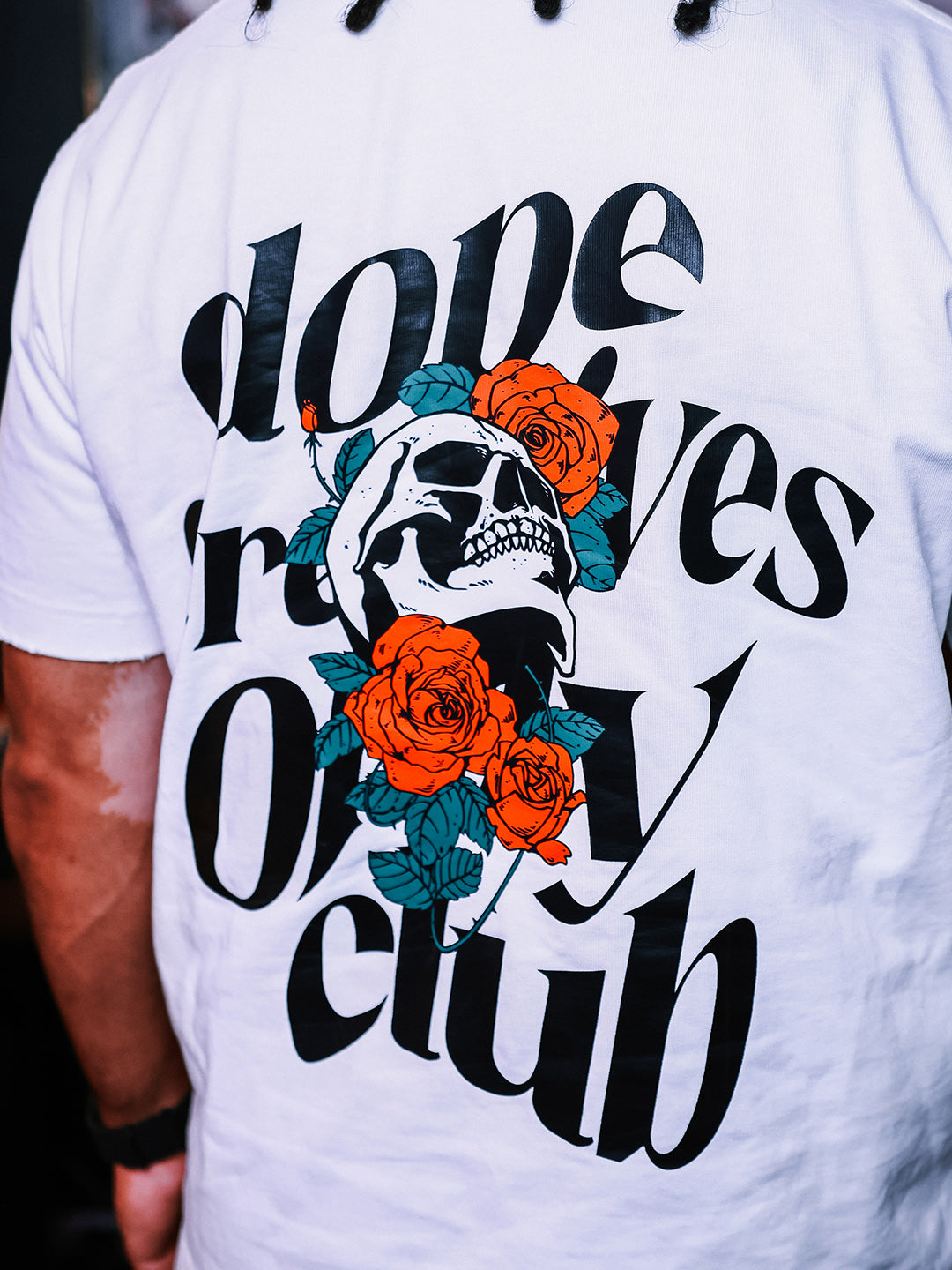 Dope Creatives Only Club back graphic with skull and orange roses on a white T-shirt