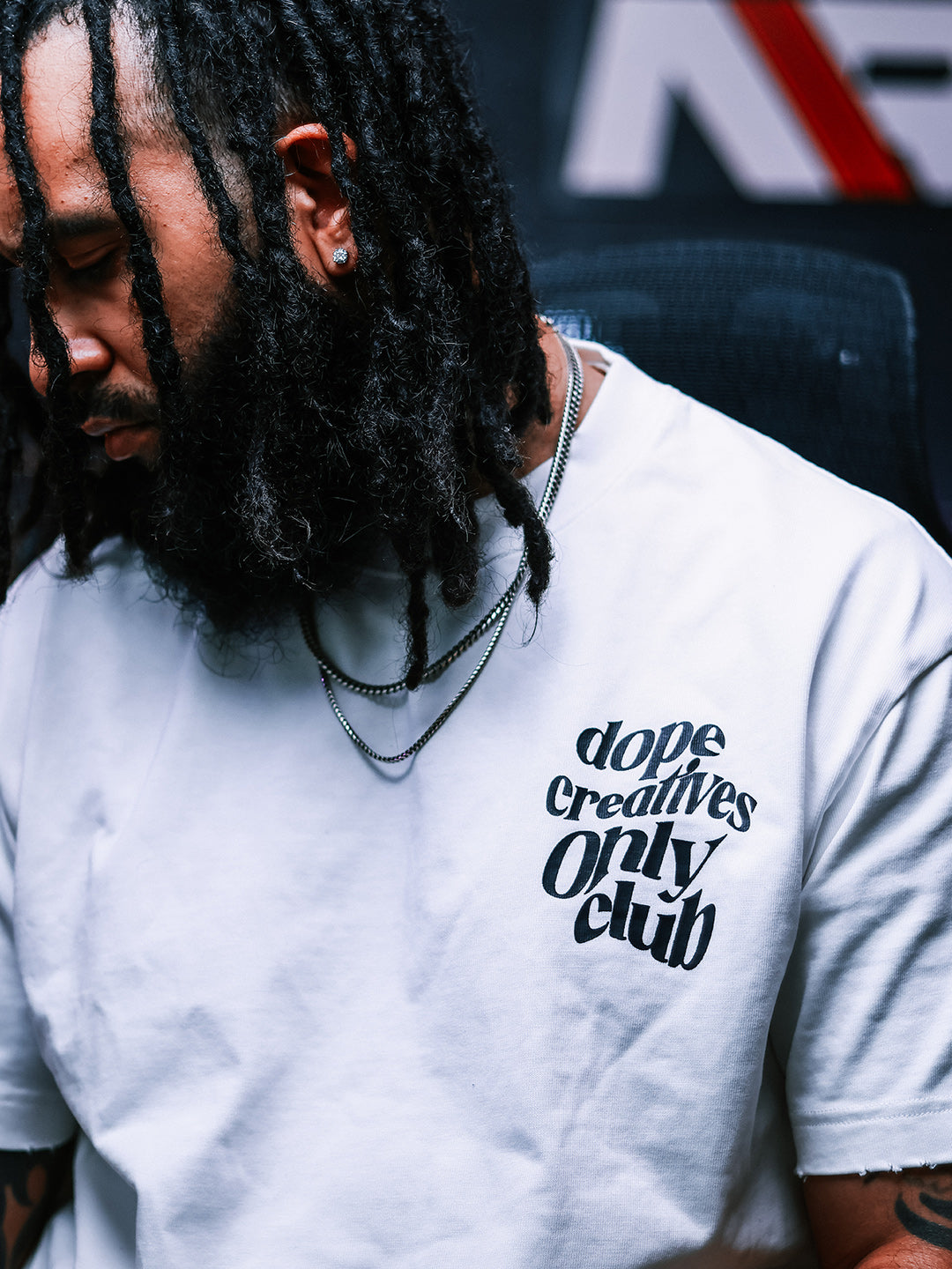 Model wearing the white Dope Creatives Only Club T-shirt